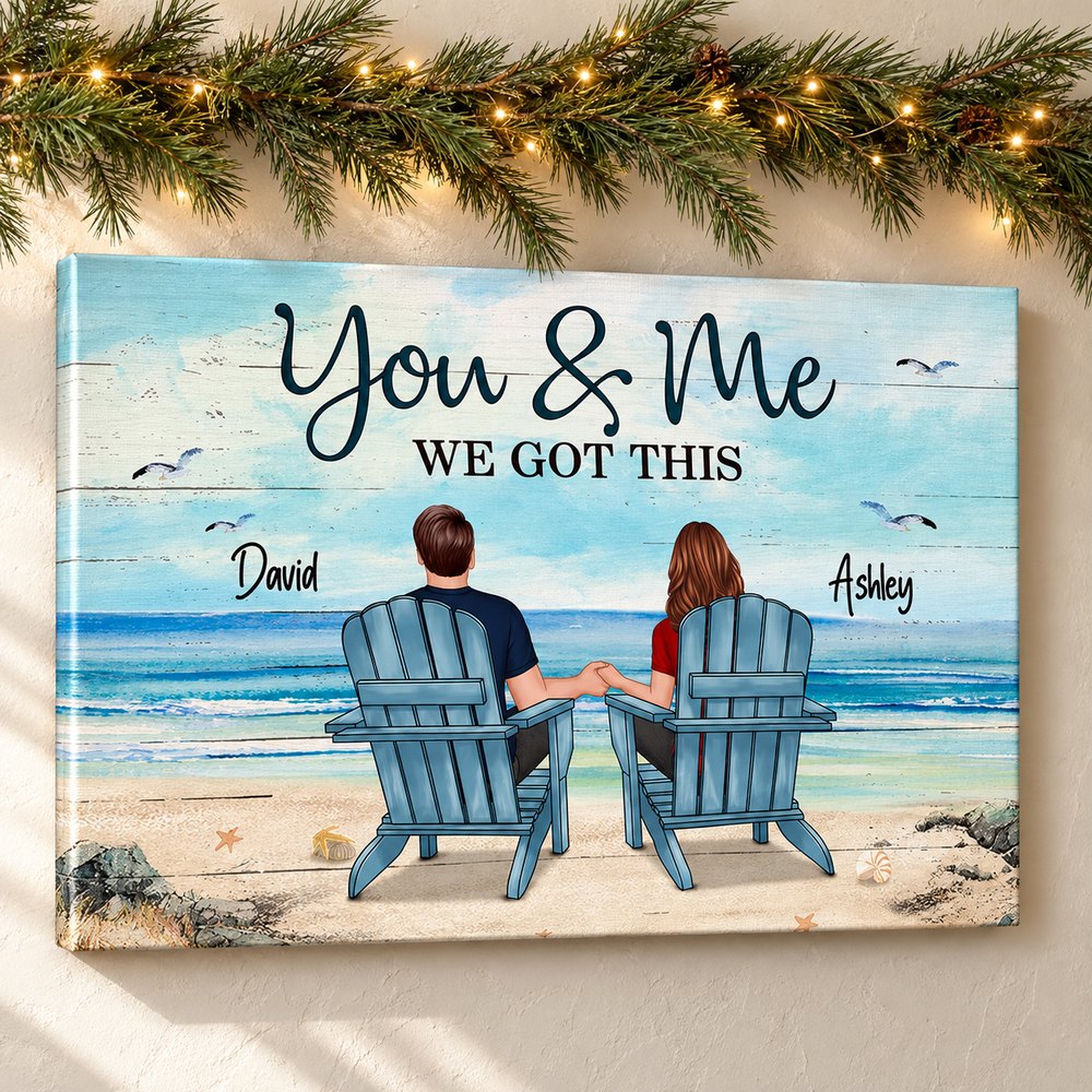 Personalized couple beach canvas wall art hanging on a wall with holiday garland and fairy lights