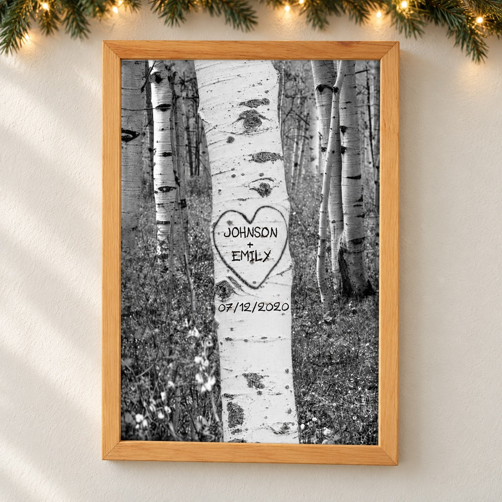 Personalized couple names tree carving framed canvas print hanging on a wall with soft holiday greenery