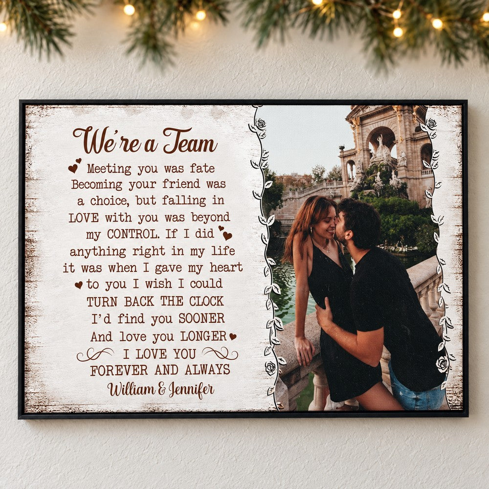 Custom photo We're A Team canvas print hanging on a wall with soft holiday greenery and fairy lights