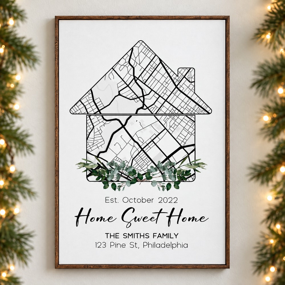 Custom home map canvas print hanging on a wall with soft holiday greenery and fairy lights