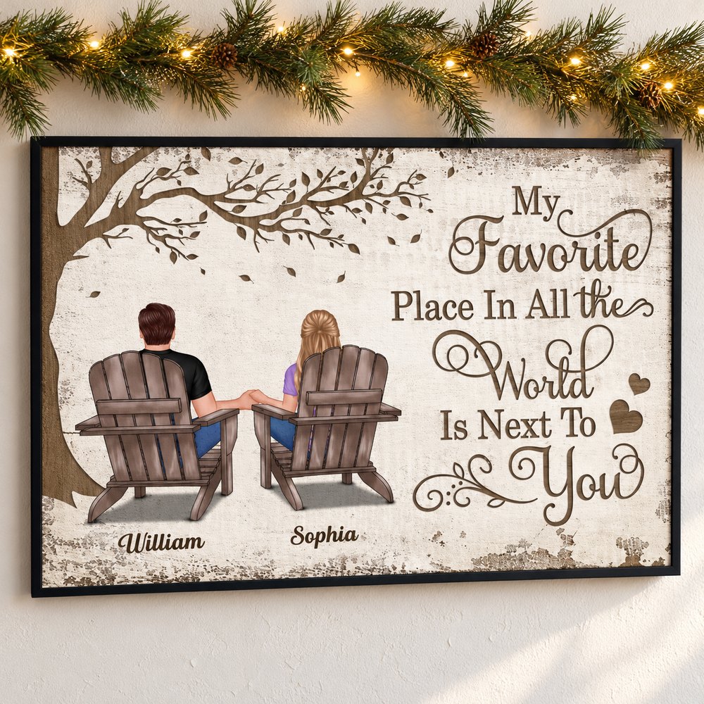 Personalized couple sitting canvas print hanging on wall with holiday pine garland and fairy lights