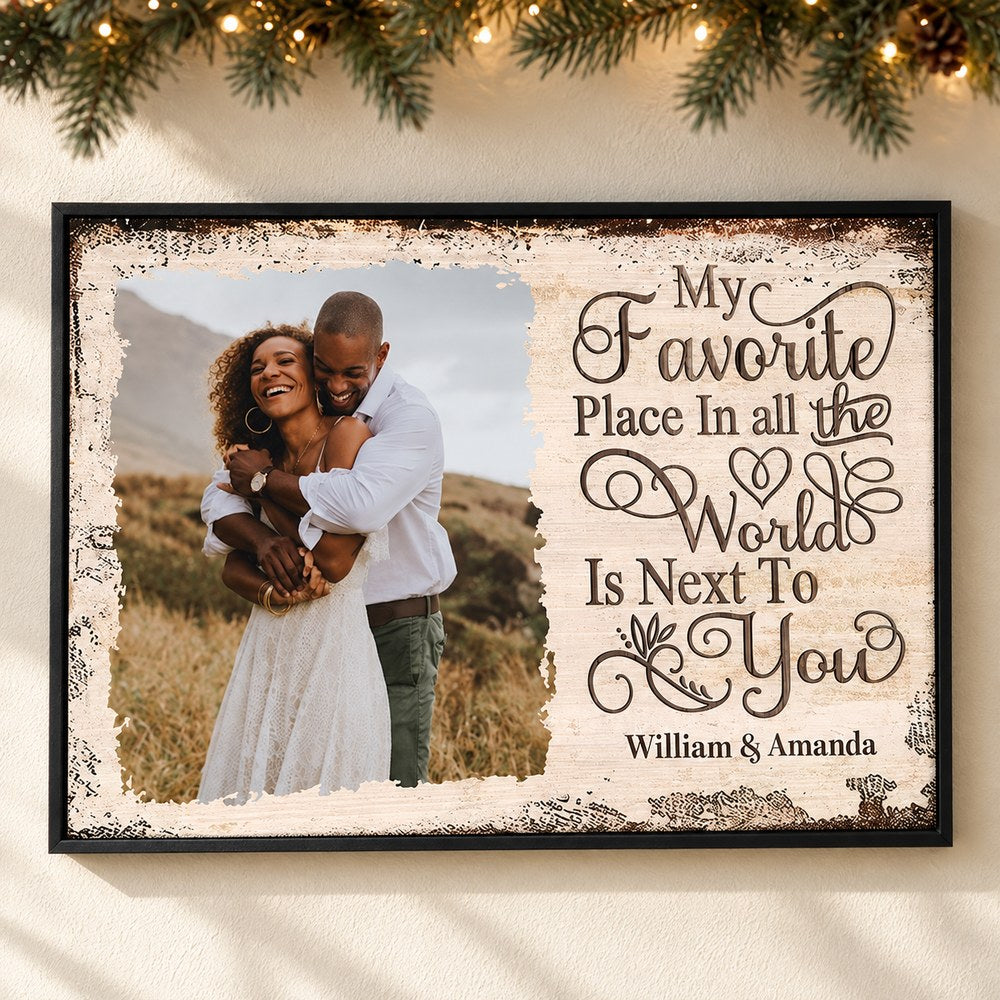 Personalized couple photo canvas print hanging on a wall with soft holiday garland and lights