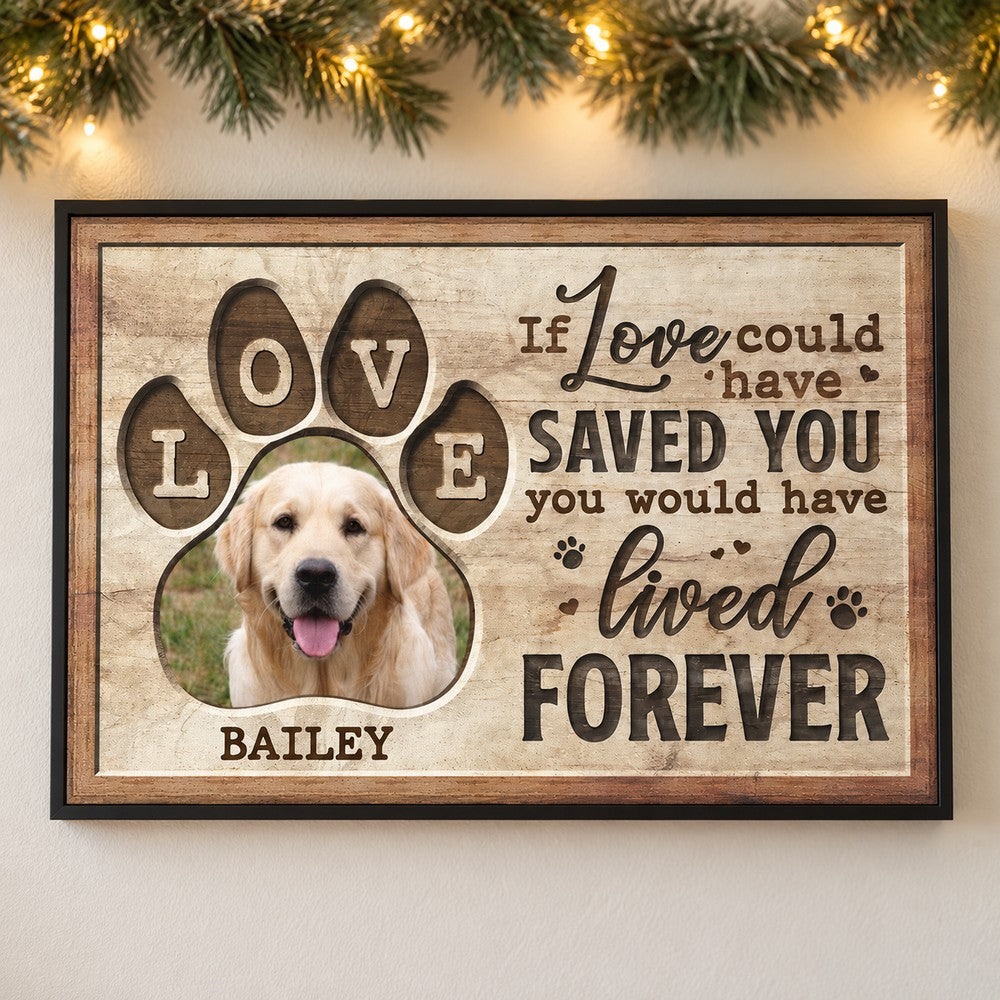 Personalized pet sympathy canvas print on a wall with soft holiday pine garland and lights