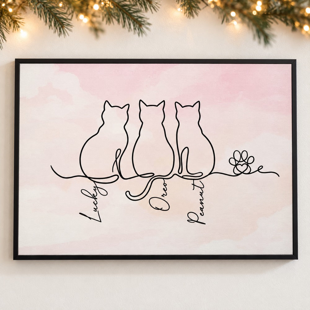 Personalized cat line art canvas print hanging on a wall with soft holiday greenery