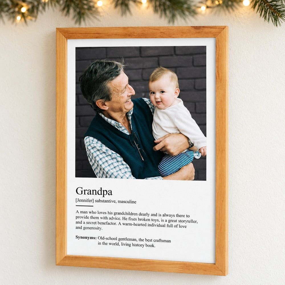 Personalized Grandpa Definition framed canvas hanging on a wall with soft holiday greenery