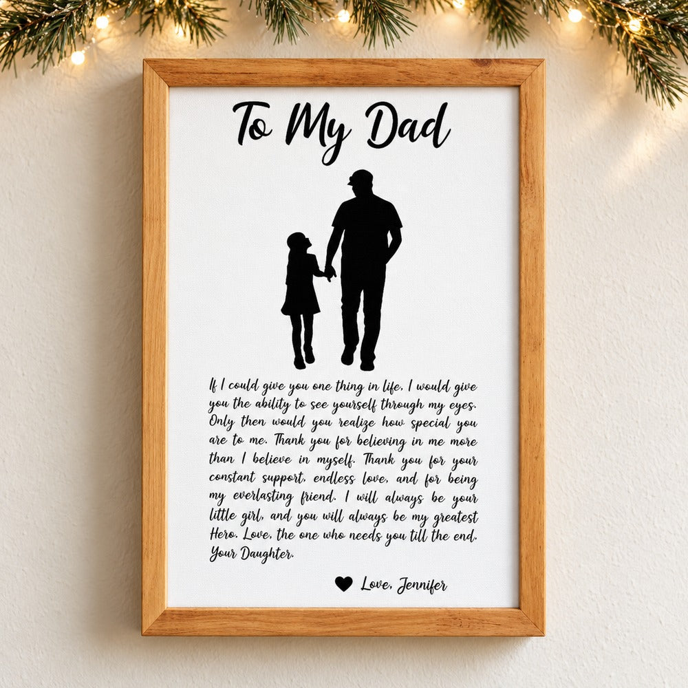 Personalized To My Dad framed canvas print hanging on a wall with holiday pine garland