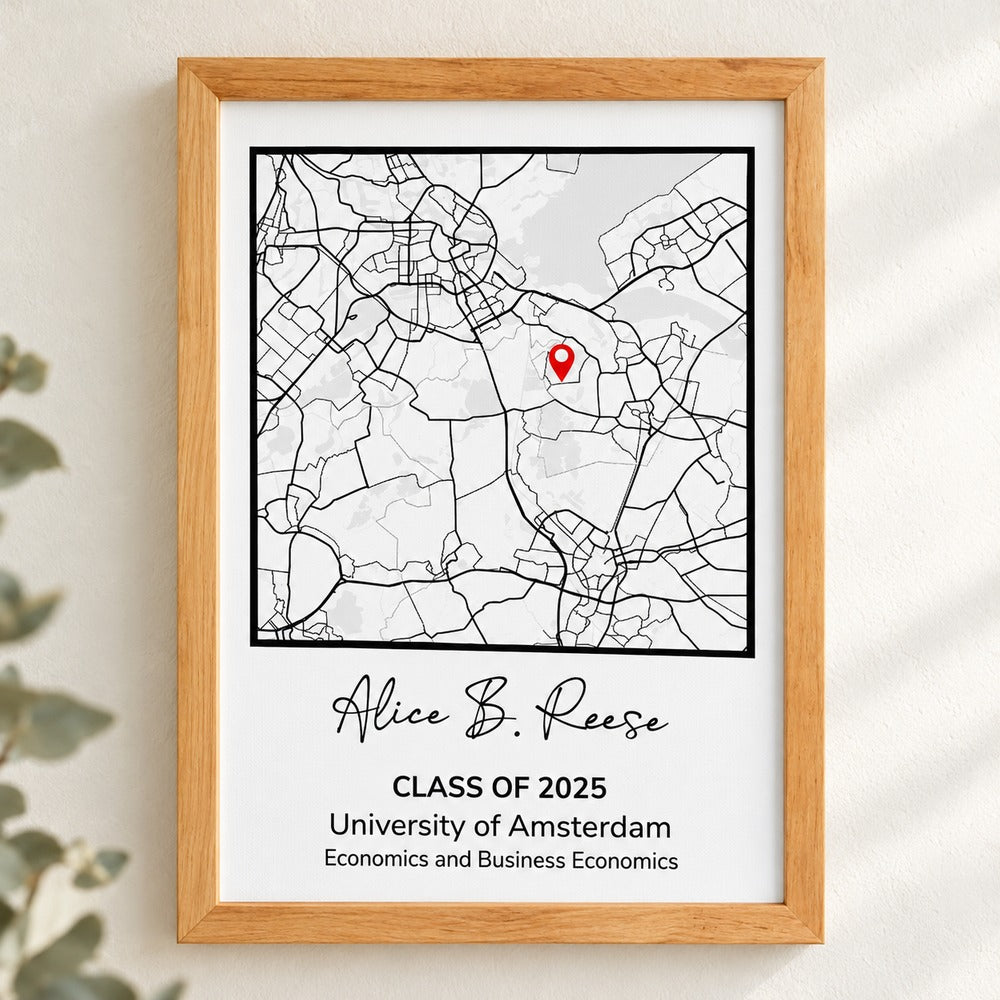 Personalized graduation map canvas print hanging on a cream wall with soft greenery