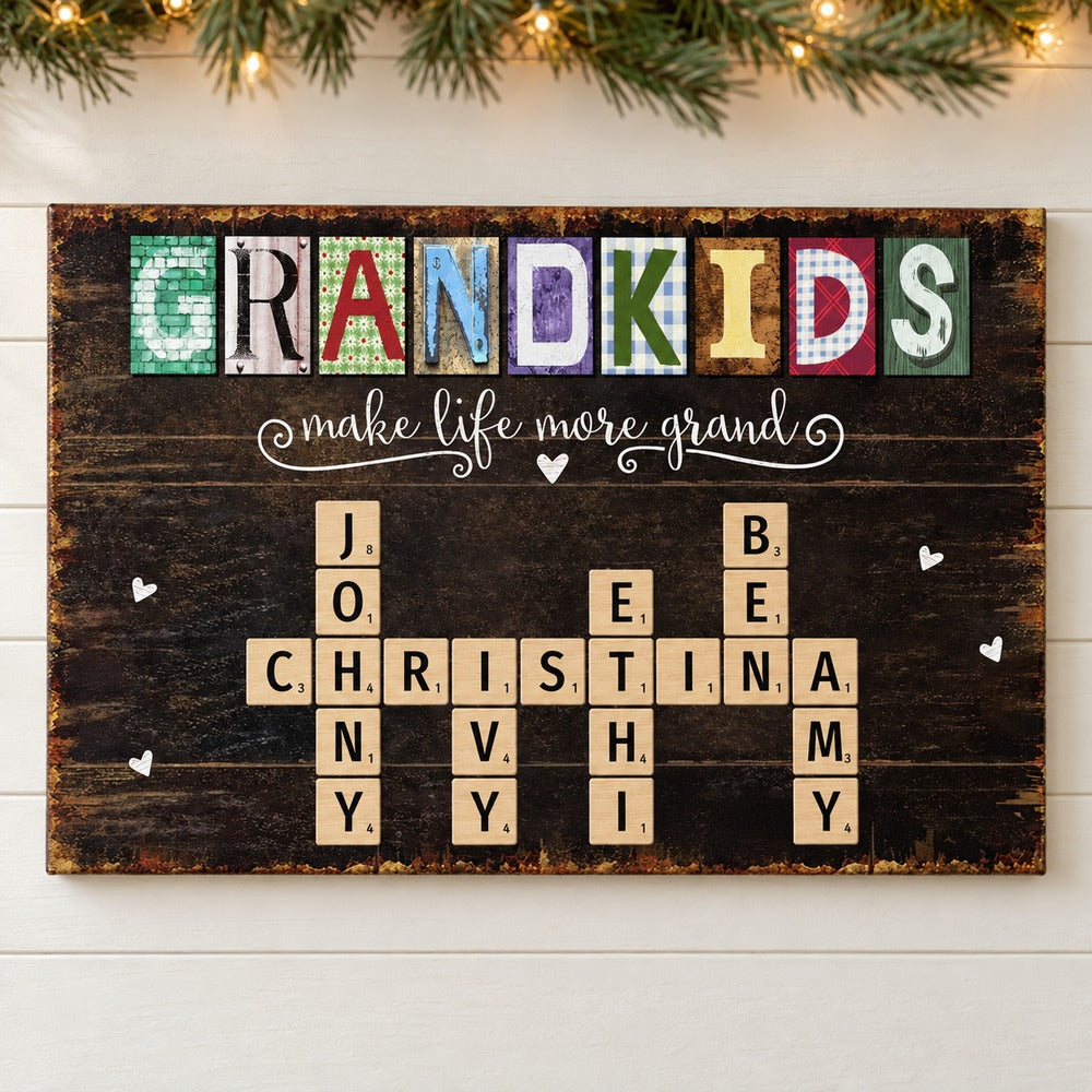 Personalized Grandkids Make Life More Grand crossword canvas hanging on wall with holiday garland