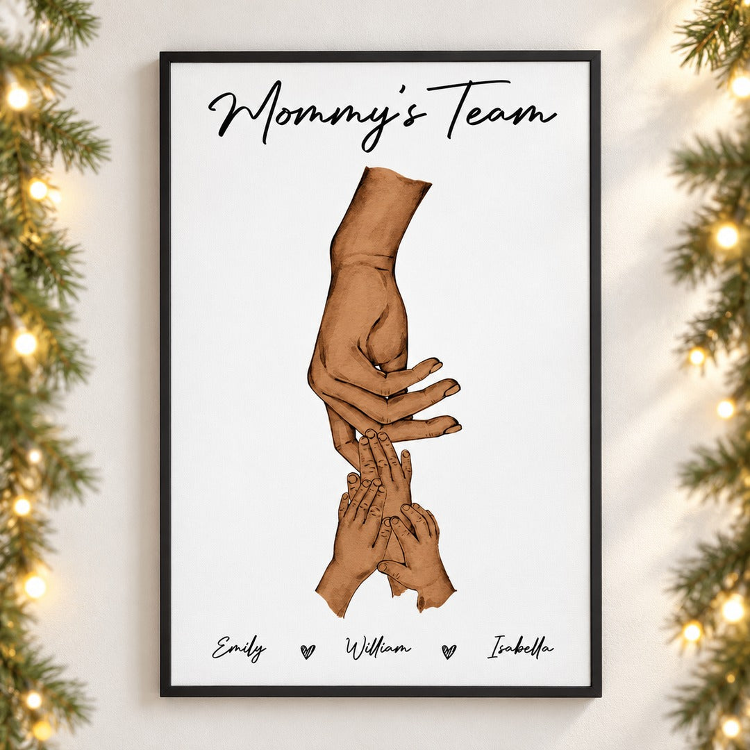 Mommy's Team personalized framed canvas print hanging on a wall with holiday garland and lights