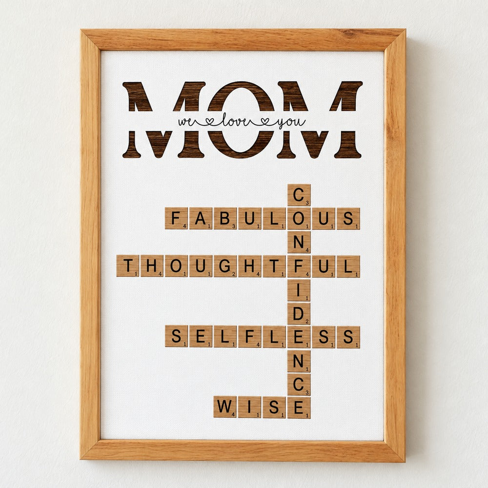 Close-up detail of personalized MOM crossword canvas texture and natural wood frame