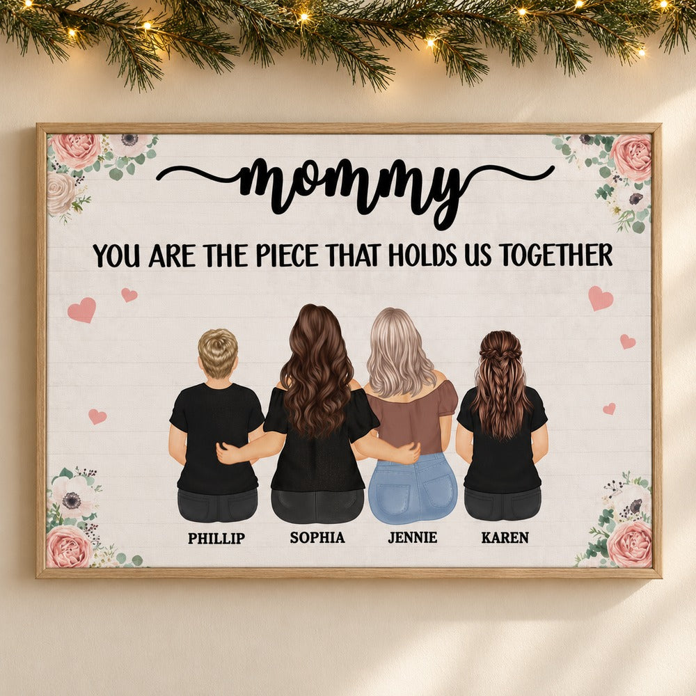 Personalized Mommy canvas wall art hanging on a wall with holiday pine garland and fairy lights
