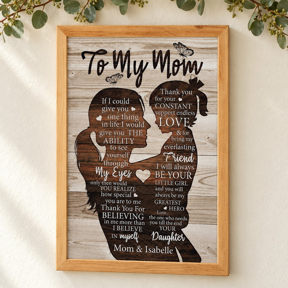 To My Mom personalized canvas print hanging on a cream wall with eucalyptus garland