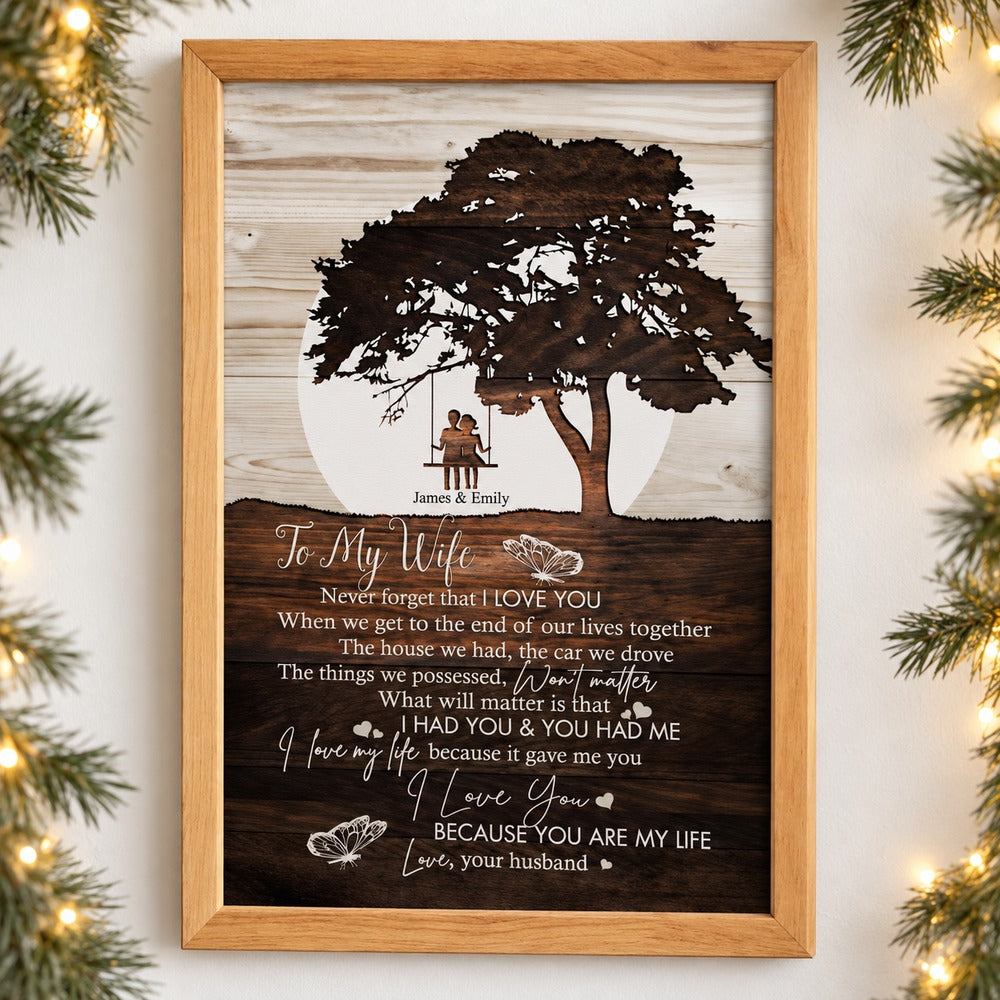 To My Wife personalized framed canvas print hanging on wall with holiday garland and fairy lights